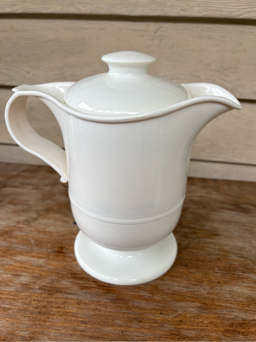 VTG JSNY insulated carafe features a white plastic exterior and a functional lid